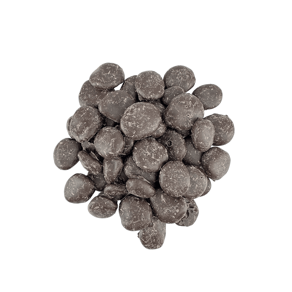 A pile of round, dark chocolate pieces, slightly uneven in texture, arranged on a plain white background. Product: Dark Chocolate Apricots - Cane Sweetened.